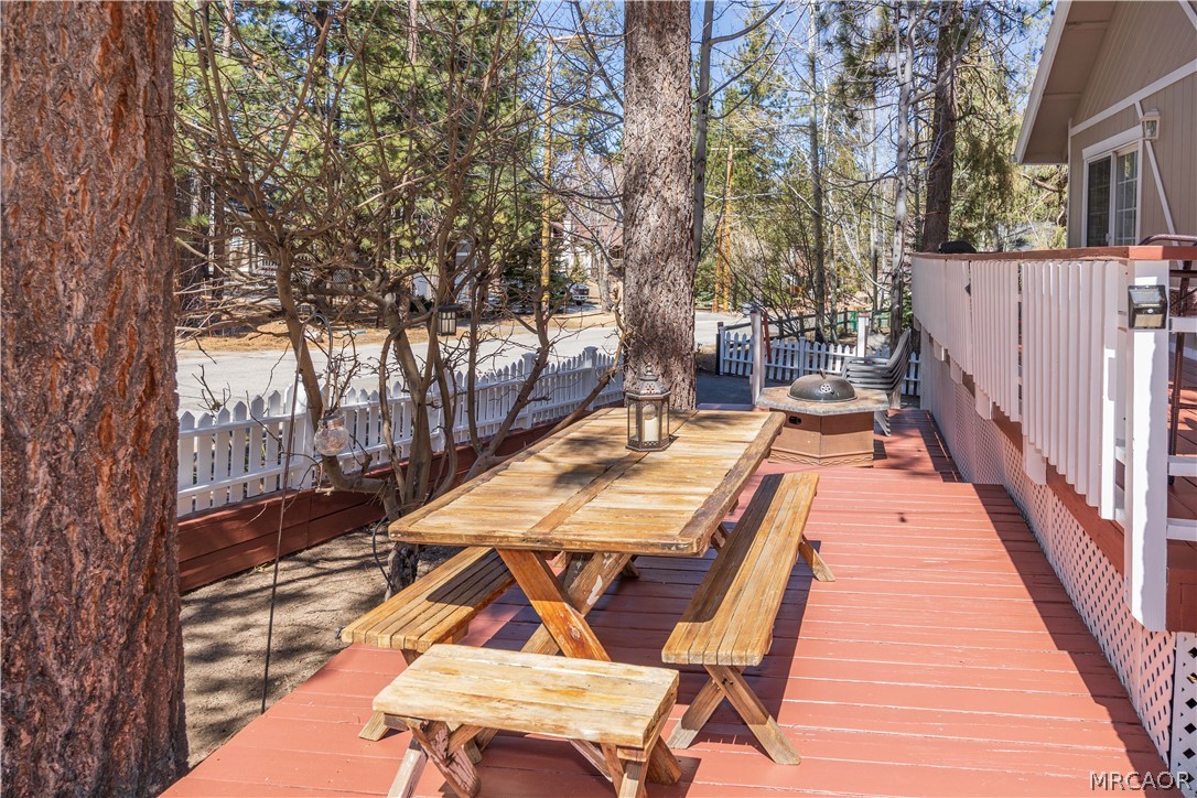 42324 Paramount Road Big Bear Lake, CA 92315 - Photo 45 of 50 a view of a patio with table and chairs with wooden floor and fence