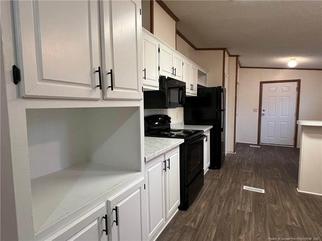 175 Travis Drive Cameron, NC 28326 - Photo 15 of 25 a kitchen with stainless steel appliances a refrigerator and a stove top oven