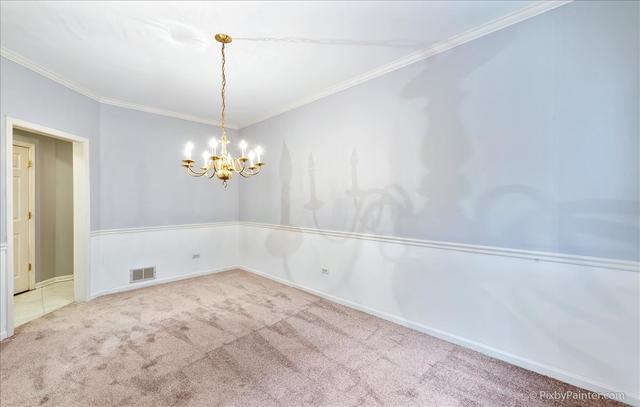 254 Charlotte Court Cary, IL 60013 - Photo 15 of 30 a view of an empty room with a chandelier fan