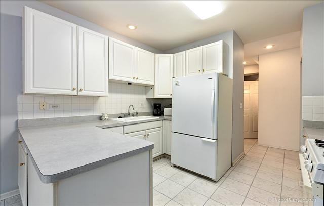 254 Charlotte Court Cary, IL 60013 - Photo 16 of 30 a kitchen with a refrigerator a stove top oven and white cabinets