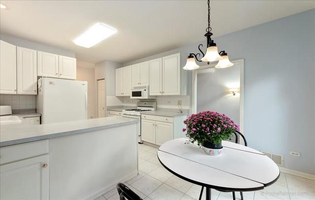254 Charlotte Court Cary, IL 60013 - Photo 20 of 30 a kitchen with cabinets a sink and white appliances