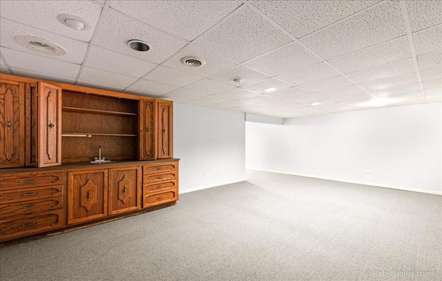 254 Charlotte Court Cary, IL 60013 - Photo 30 of 30 a kitchen with granite countertop a stove and a sink with cabinets