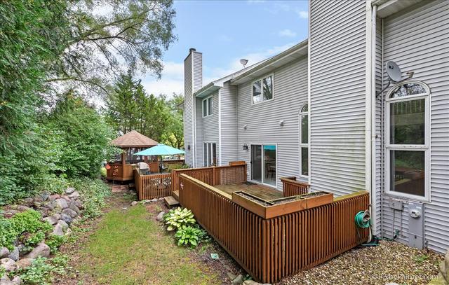 254 Charlotte Court Cary, IL 60013 - Photo 6 of 30 a view of a chairs with barbeque grill and a small yard