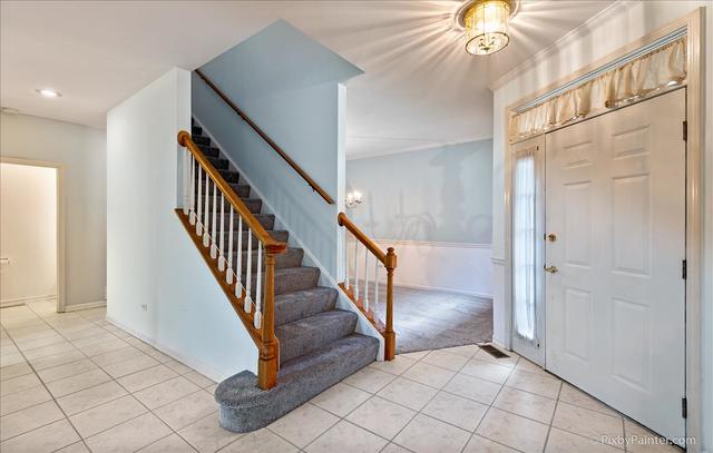 254 Charlotte Court Cary, IL 60013 - Photo 9 of 30 wooden floor with windows and entryway