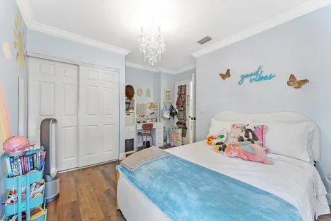 a bedroom with a bed and a dresser in it