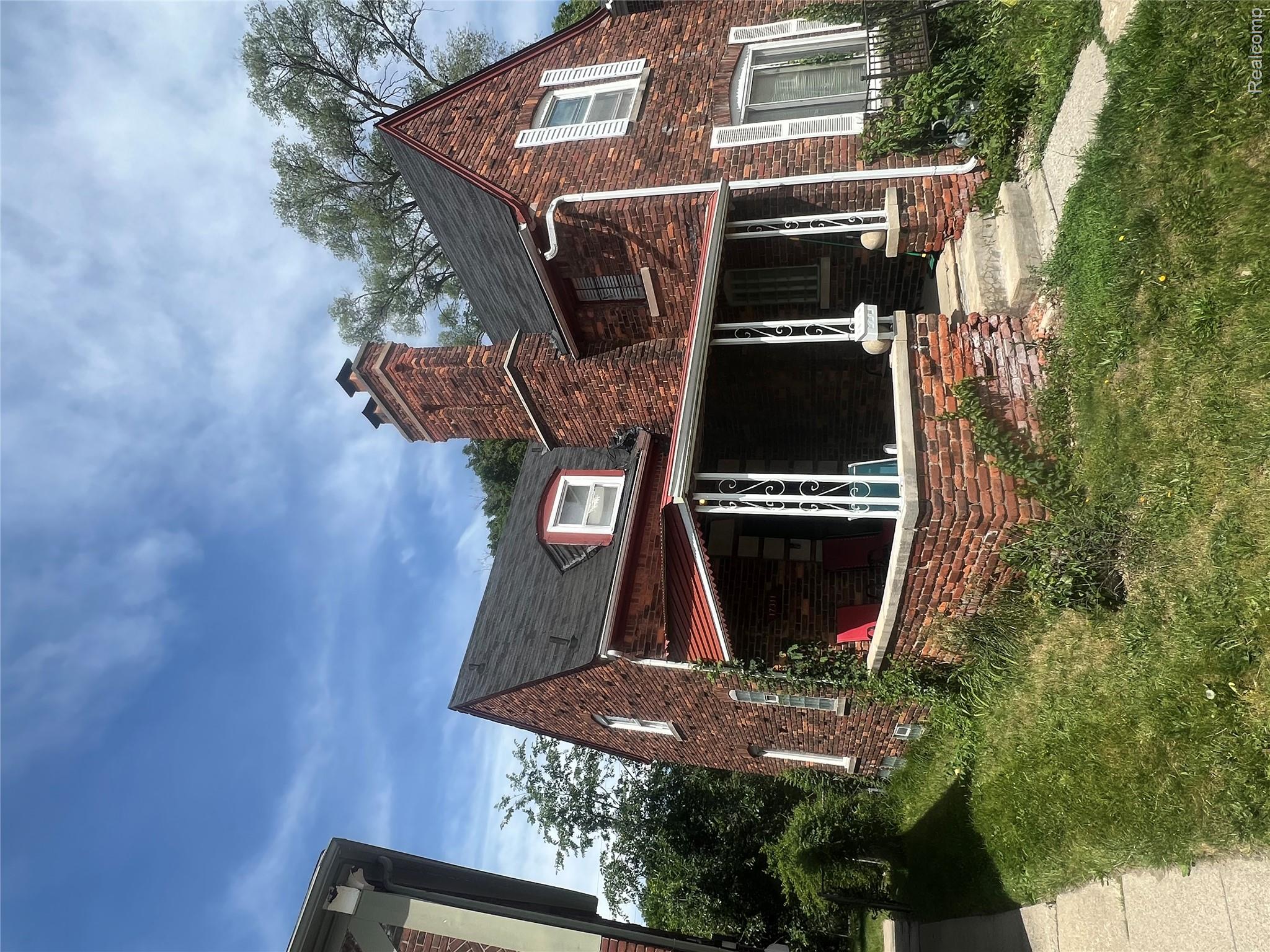 17311 Santa Rosa Drive Detroit, MI 48221 - Photo 2 of 89 Brick exterior residence featuring a covered front porch with decorative metal railings