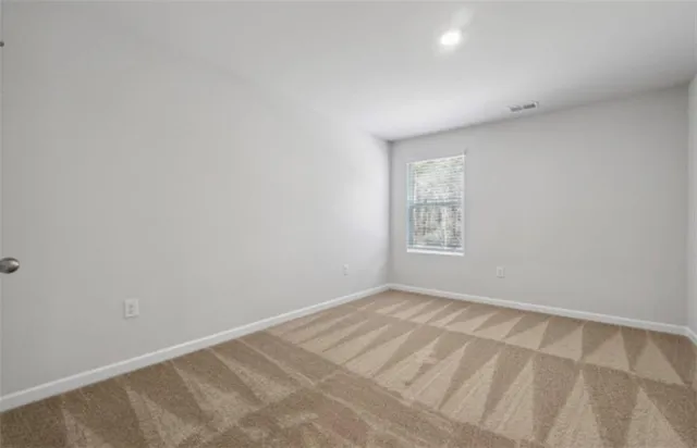 a bathroom with a granite countertop shower and a sink