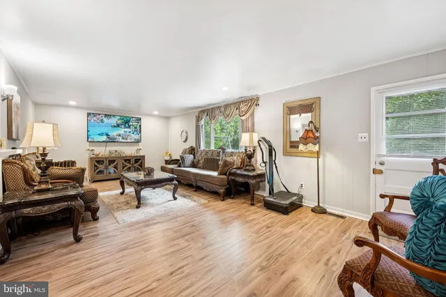 a bedroom with furniture and a wooden floor