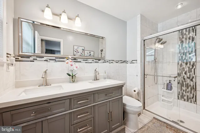 a bathroom with a sink a toilet and shower curtain