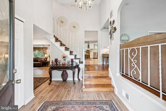 a view of a hallway with wooden floor and stairs