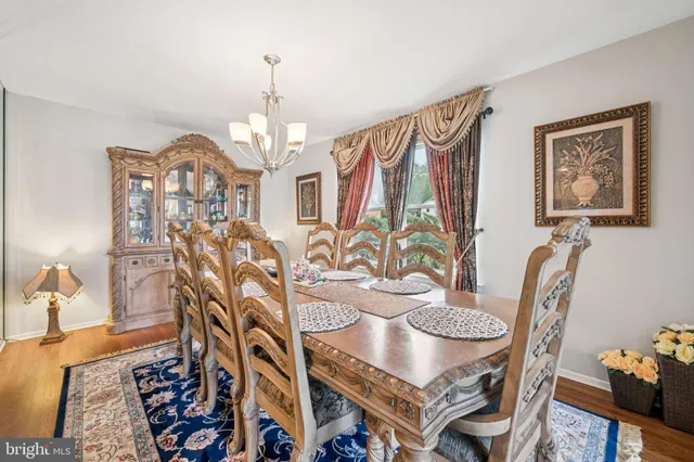 a view of a dining room with furniture and chandelier