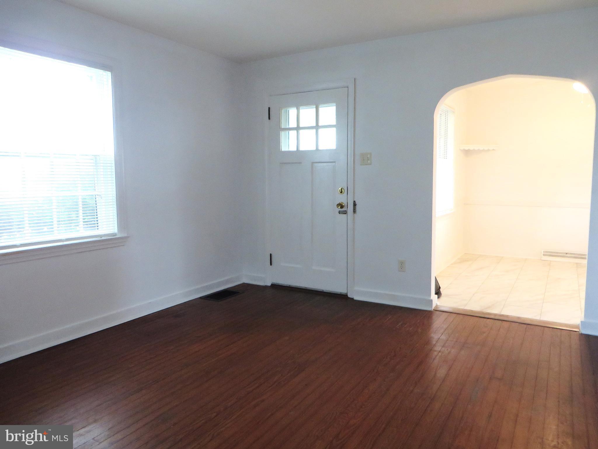 109 Chestnut Street Lititz, PA 17543 - Photo 6 of 15 an empty room with wooden floor and windows