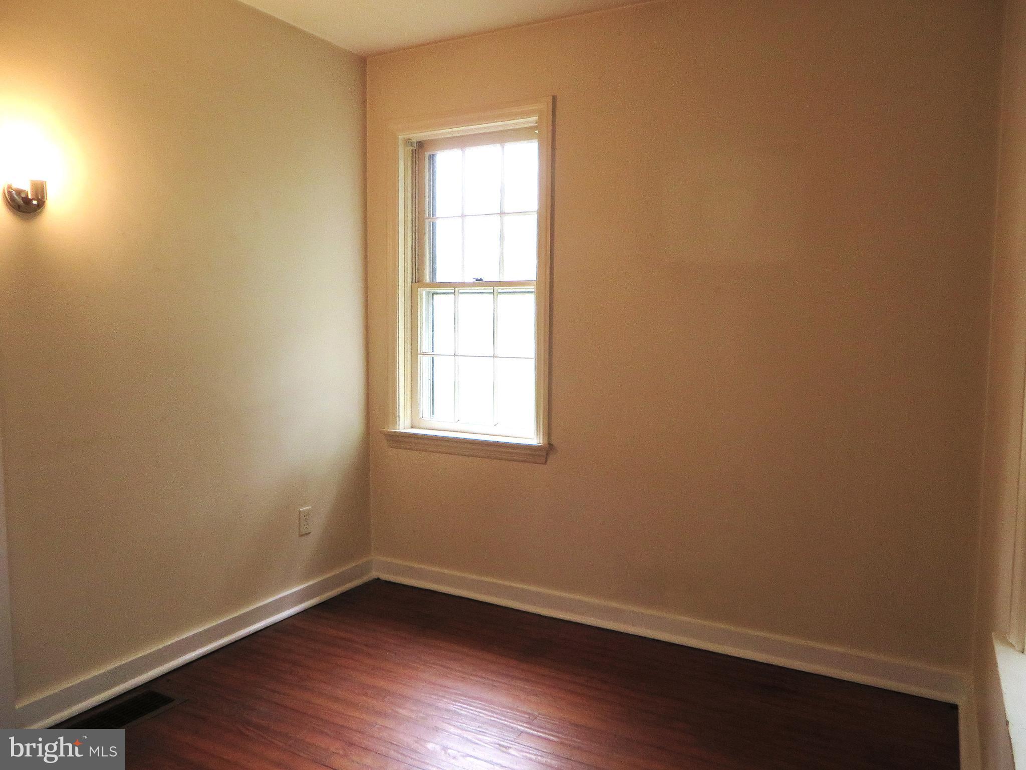 109 Chestnut Street Lititz, PA 17543 - Photo 10 of 15 an empty room with wooden floor and windows