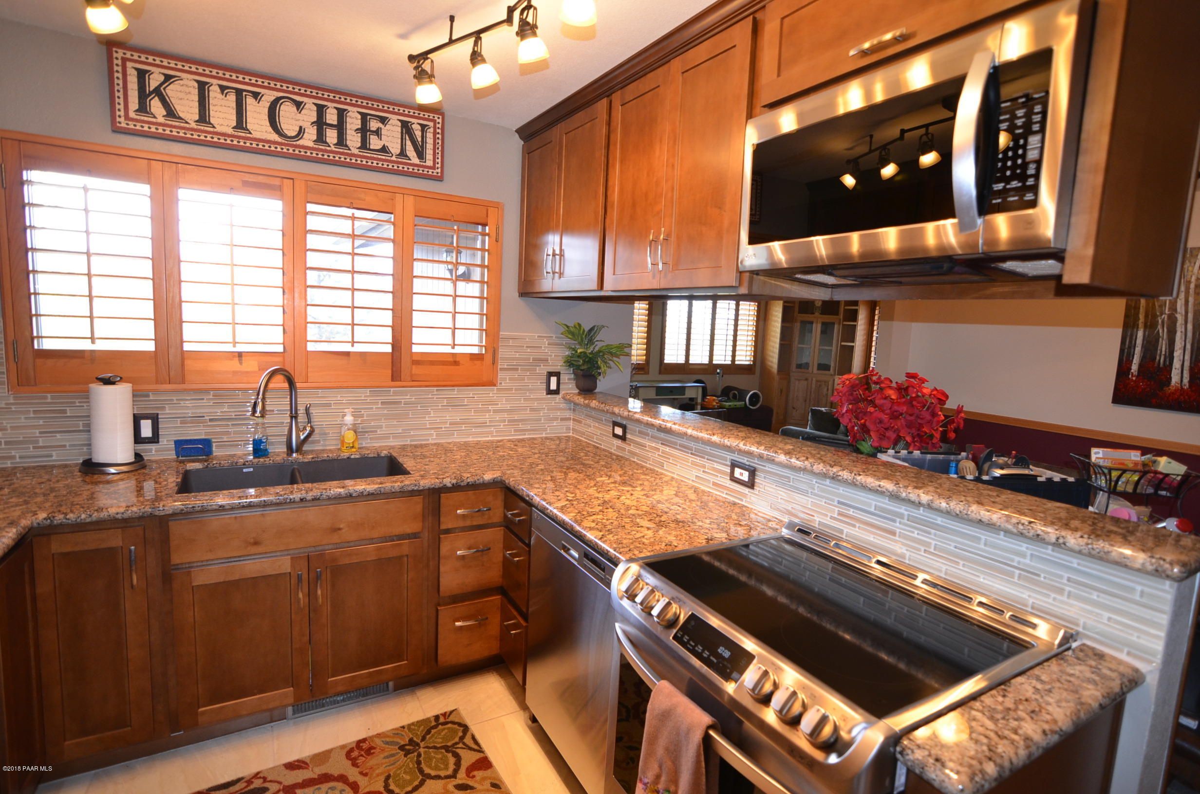 1251 Tanglewood Road Prescott, AZ 86303 - Photo 12 of 39 a kitchen with a sink stove and cabinets