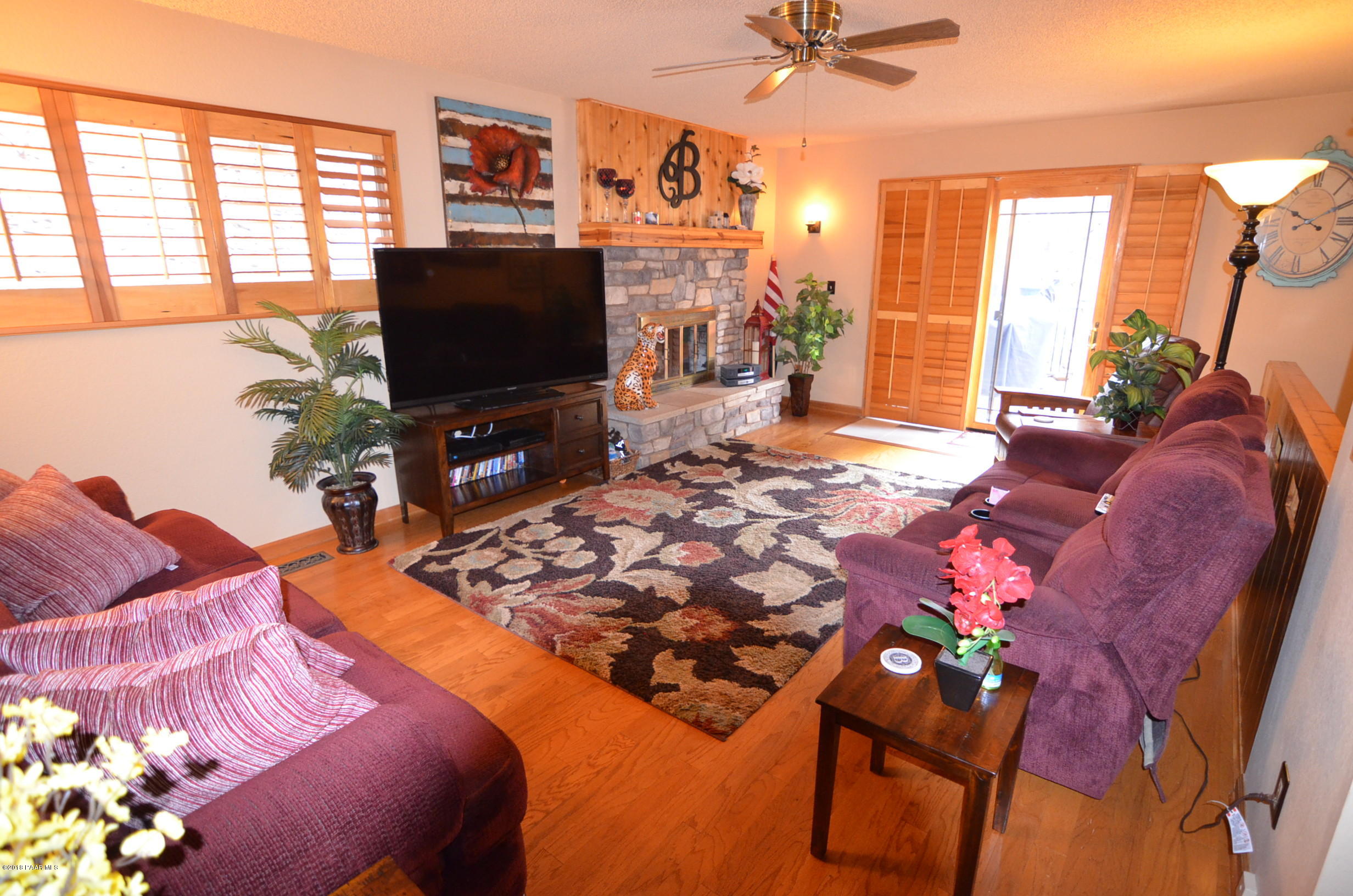 1251 Tanglewood Road Prescott, AZ 86303 - Photo 14 of 39 a living room with a flat screen tv and a floor to ceiling window