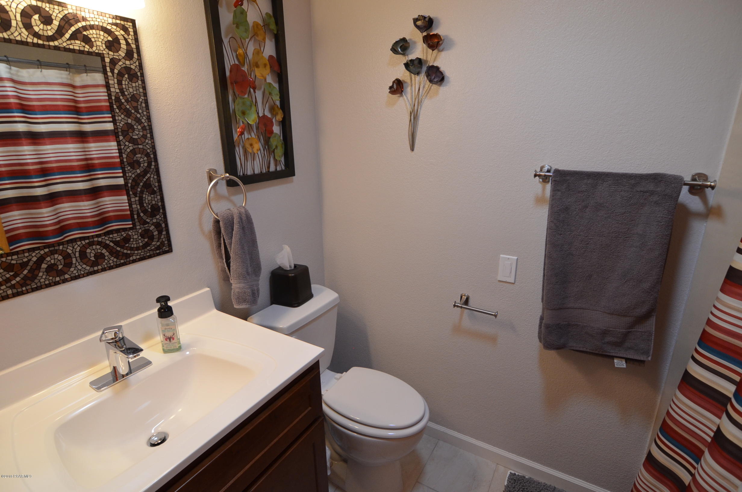 1251 Tanglewood Road Prescott, AZ 86303 - Photo 21 of 39 a bathroom with a sink toilet and mirror