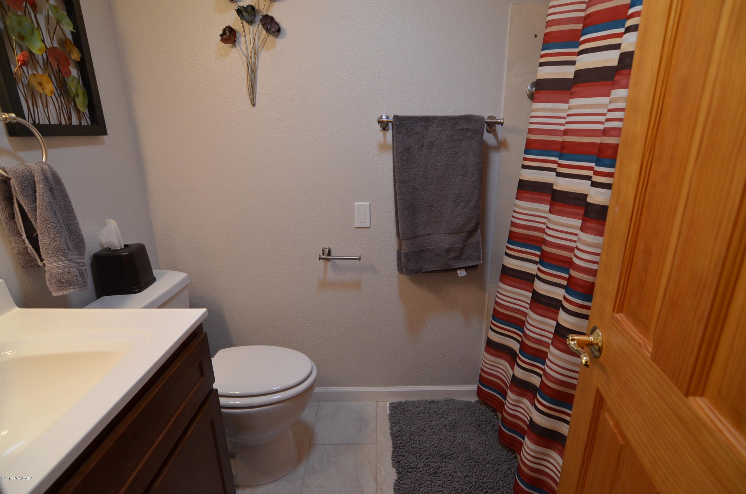 1251 Tanglewood Road Prescott, AZ 86303 - Photo 23 of 39 a bathroom with a sink a toilet and a shower