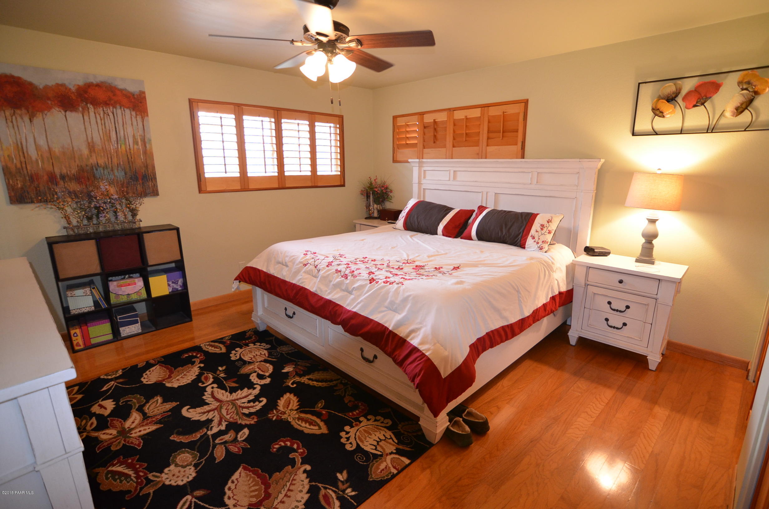 1251 Tanglewood Road Prescott, AZ 86303 - Photo 26 of 39 a bedroom with a bed and wooden floor