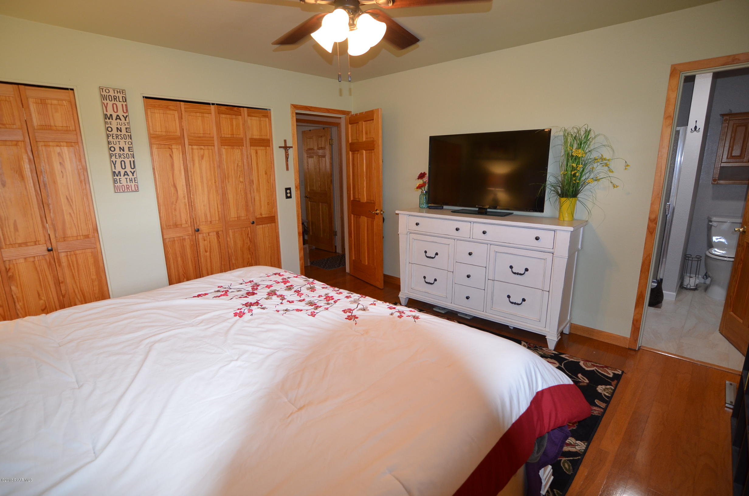 1251 Tanglewood Road Prescott, AZ 86303 - Photo 27 of 39 a bedroom with a bed and a flat screen tv