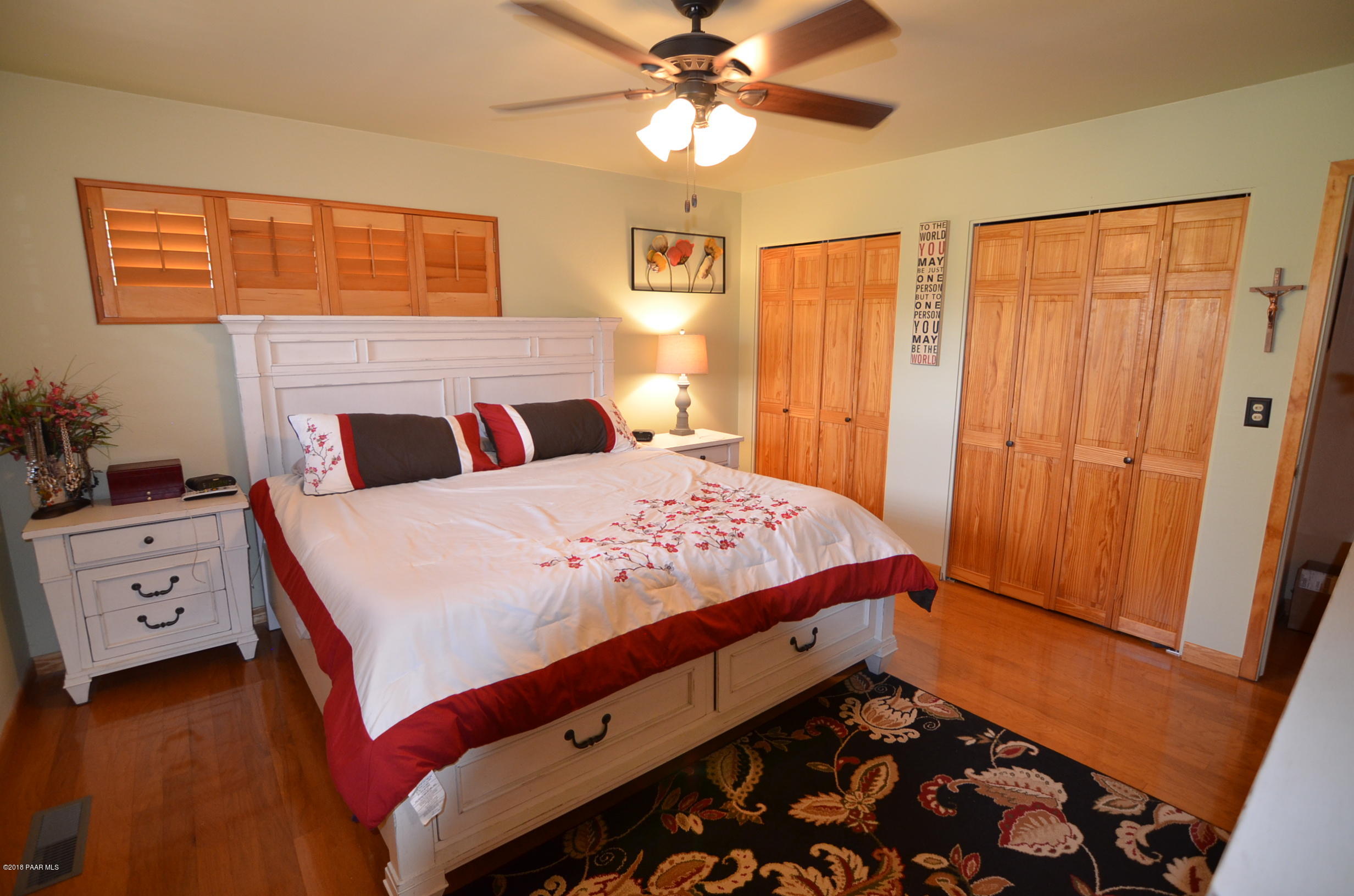 1251 Tanglewood Road Prescott, AZ 86303 - Photo 30 of 39 a bedroom with a bed and a chandelier