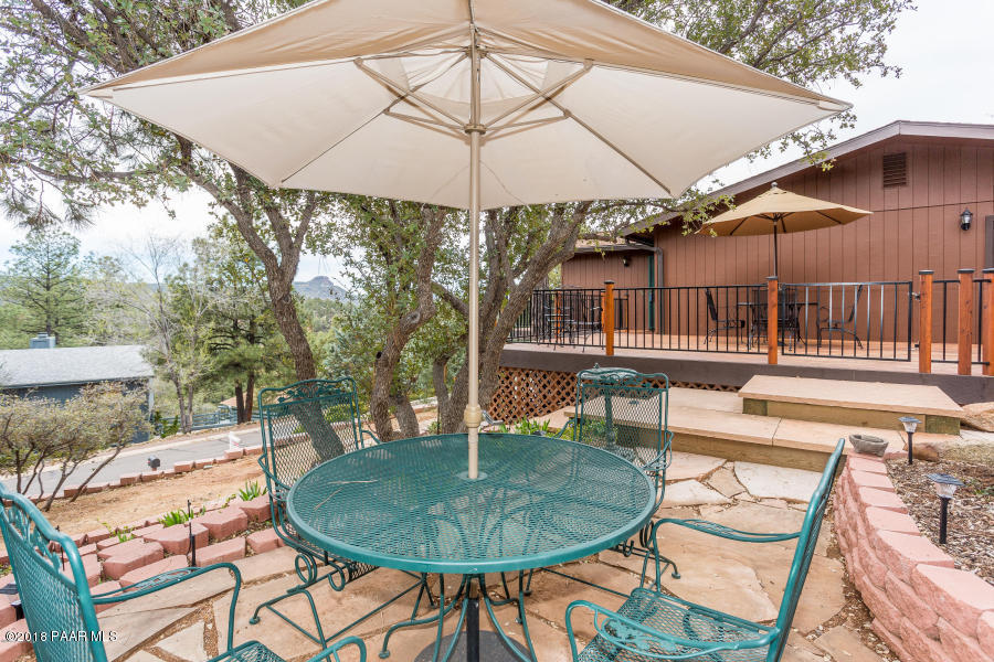 1251 Tanglewood Road Prescott, AZ 86303 - Photo 3 of 39 a backyard of a house with table and chairs