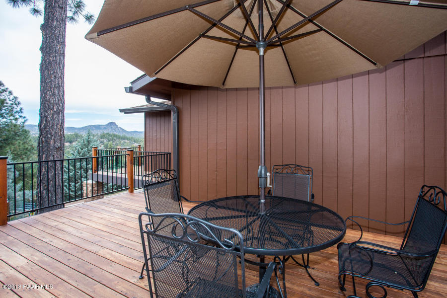 1251 Tanglewood Road Prescott, AZ 86303 - Photo 4 of 39 a patio with a table and chairs