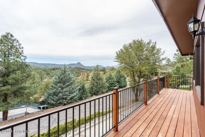 1251 Tanglewood Road Prescott, AZ 86303 - Photo 8 of 39 a view of a balcony with wooden floor and fence
