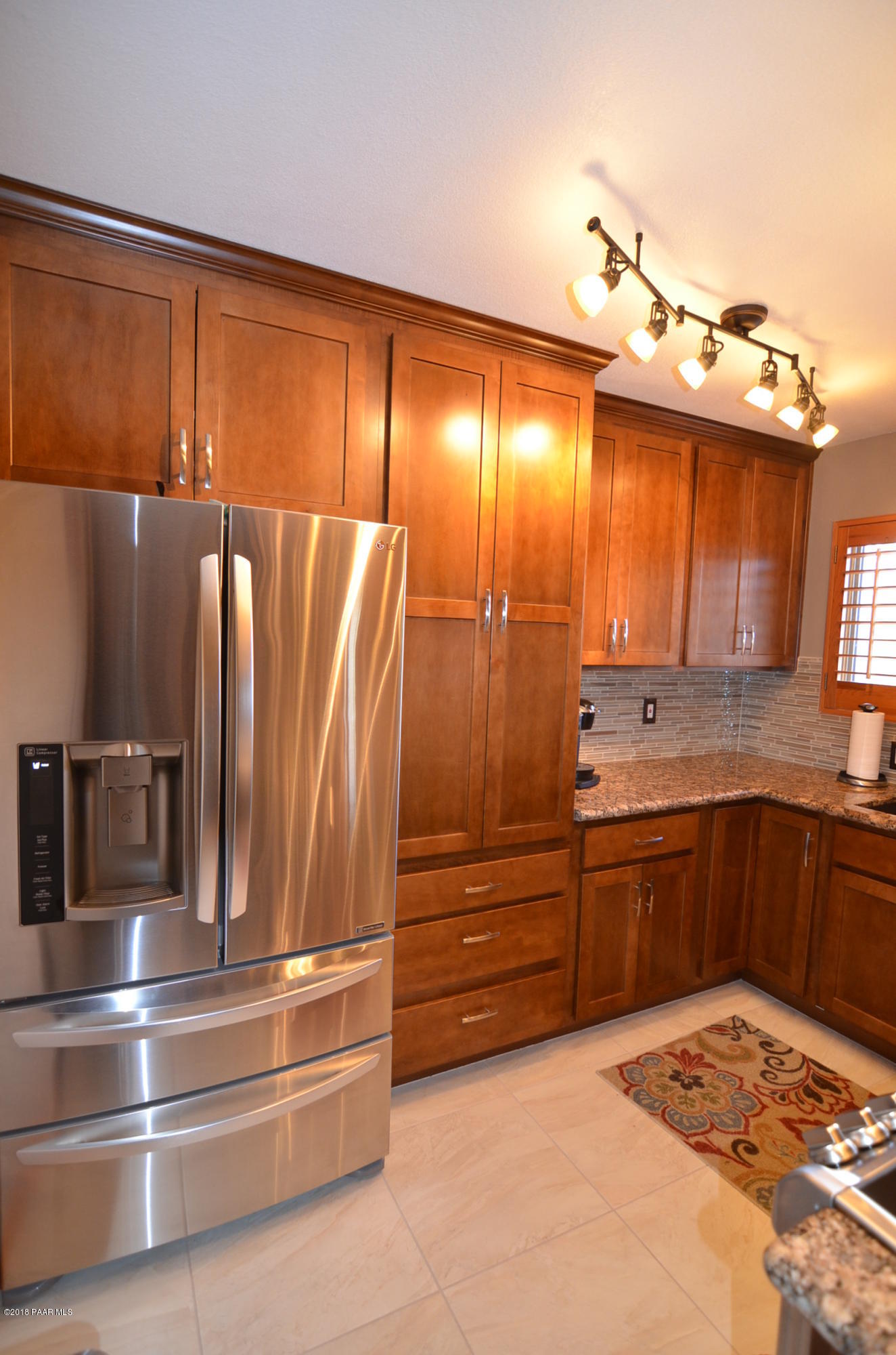 1251 Tanglewood Road Prescott, AZ 86303 - Photo 10 of 39 a kitchen with kitchen island a counter top space appliances and cabinets