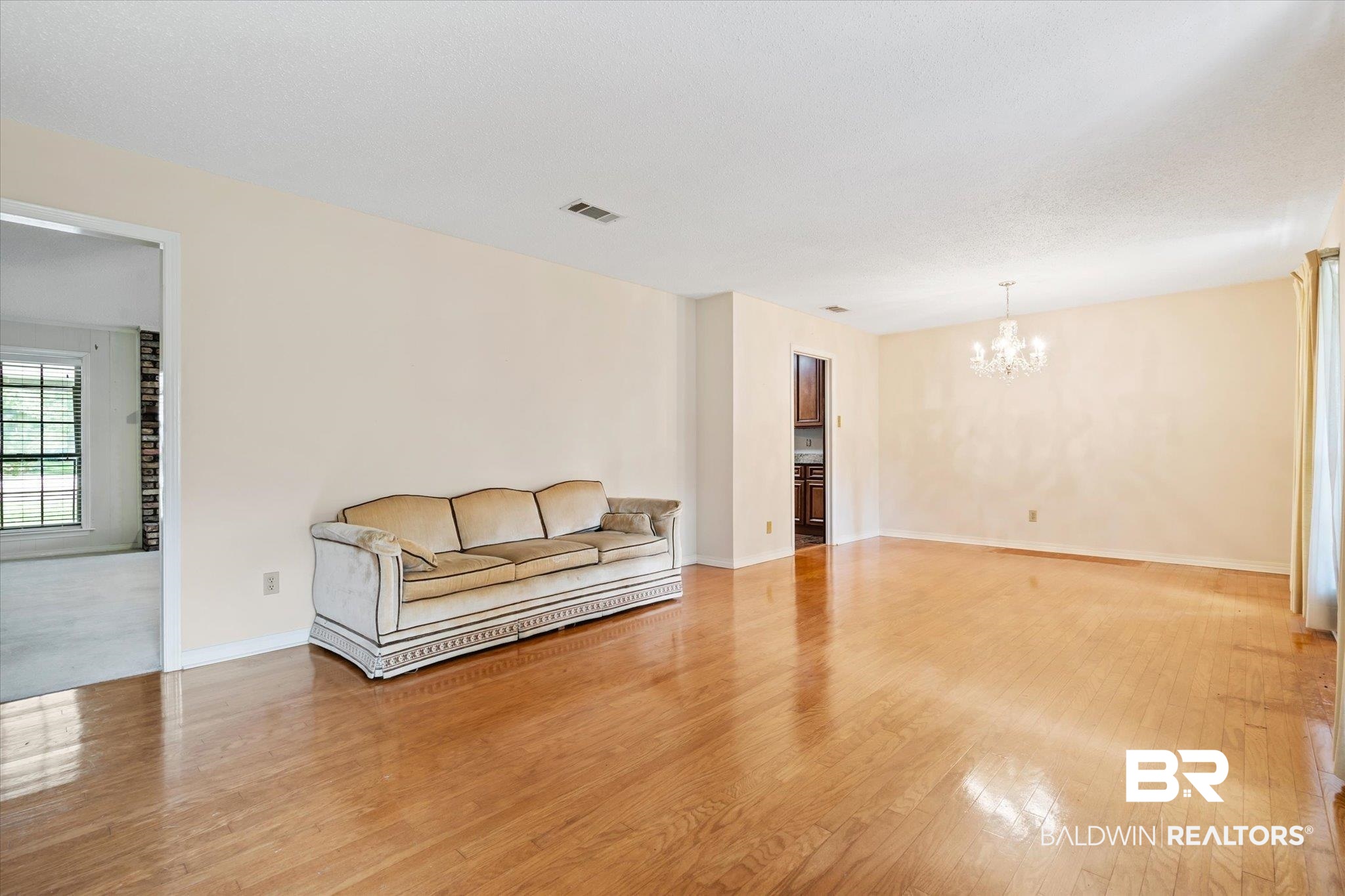 9623 Sunview Drive Semmes, AL 36575 - Photo 4 of 30 Unfurnished living room featuring an inviting chandelier and light hardwood / wood-style flooring