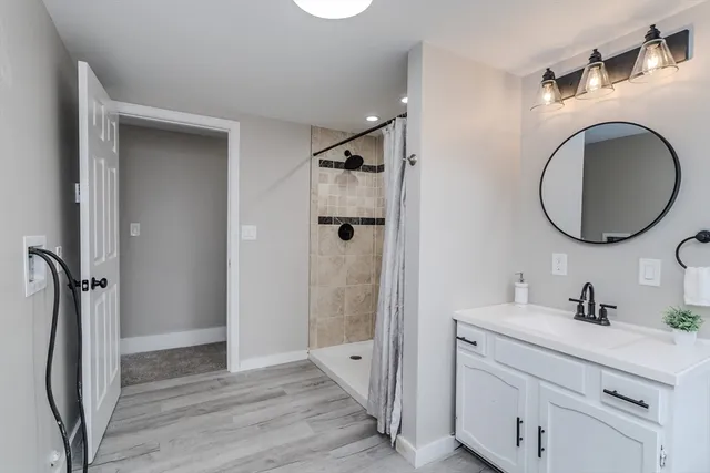 a bathroom with a sink a toilet and shower