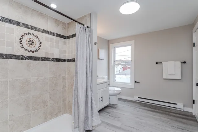 a bathroom with a shower toilet and sink