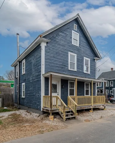 a view of a house with a garden and pathway
