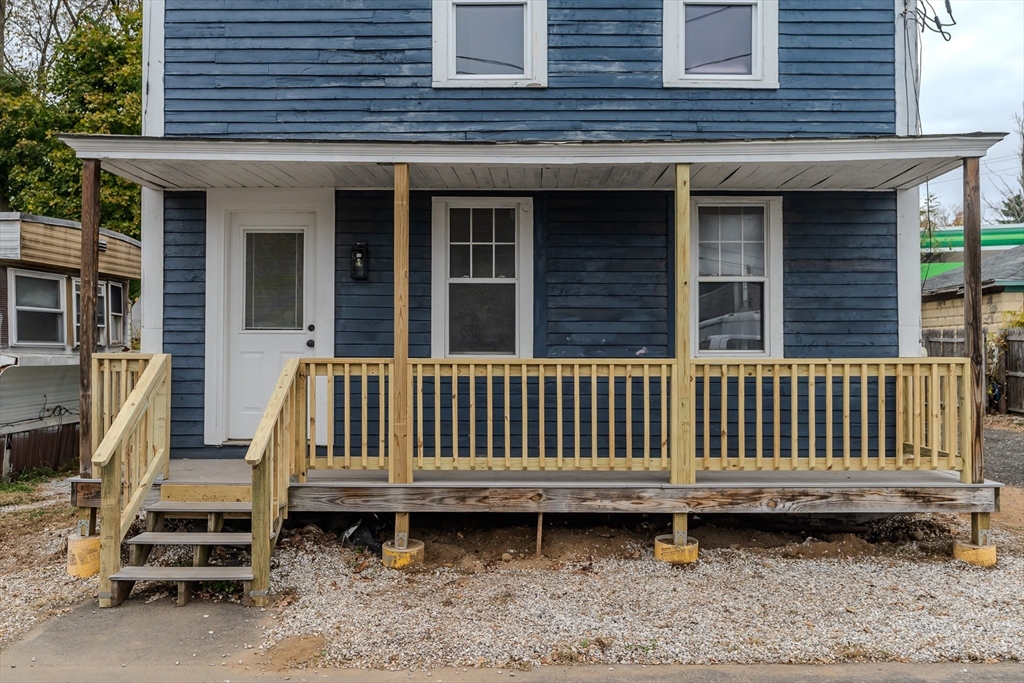 7 Webb Court Ware, MA 01082 - Photo 29 of 29 a view of a brick house with wooden deck and furniture