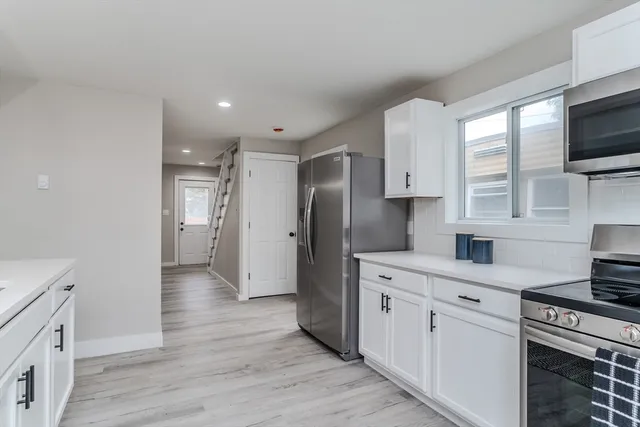 a kitchen with stainless steel appliances a refrigerator stove and sink