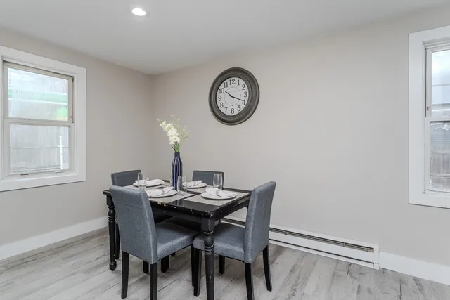 a view of a dining room with furniture and a window