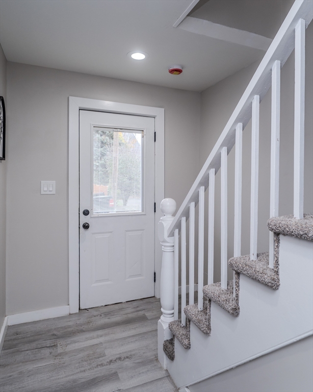 7 Webb Court Ware, MA 01082 - Photo 9 of 29 a view of a hallway with wooden floor and staircase