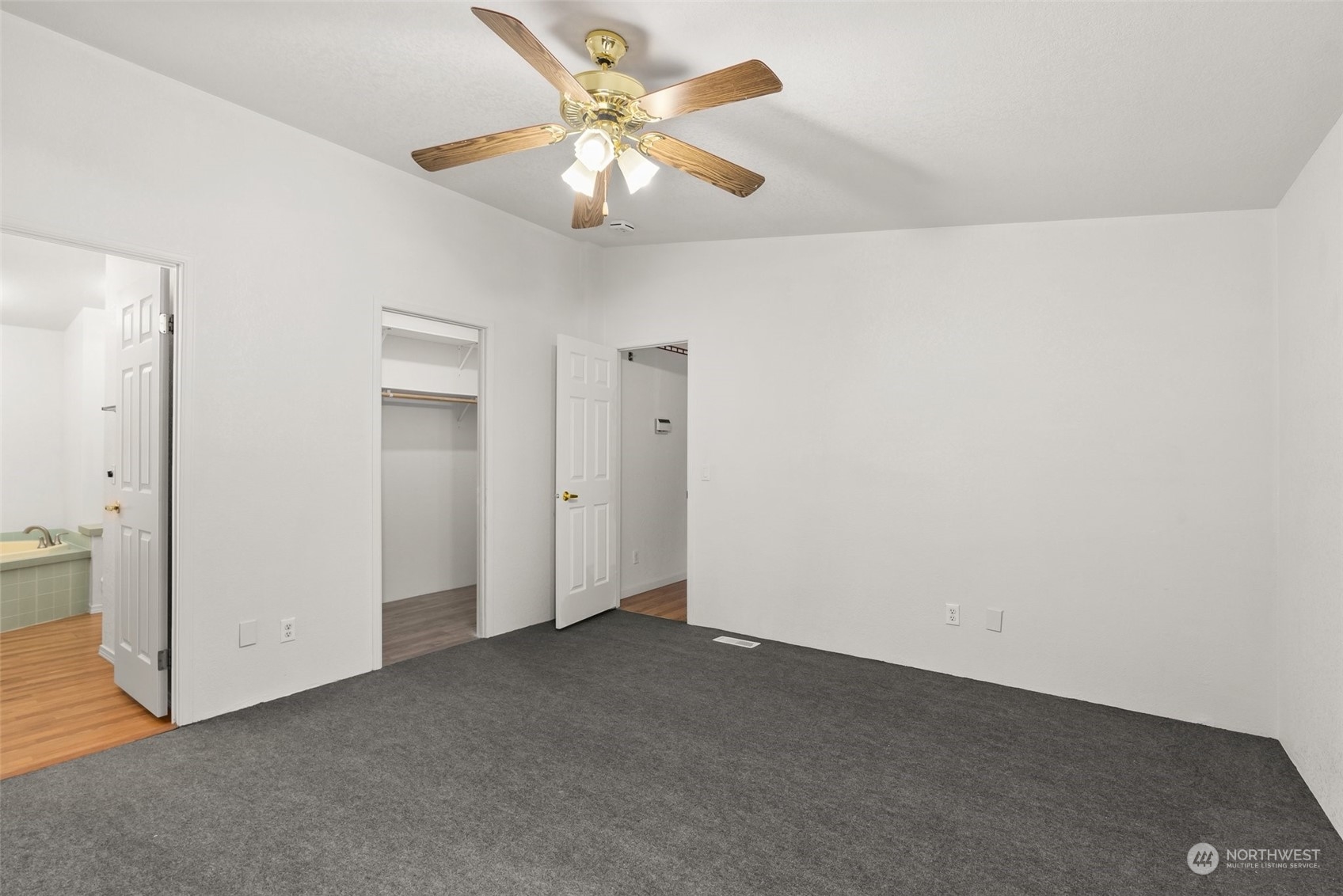 669 Twin Oaks Road Chehalis, WA 98532 - Photo 12 of 33 an empty room with a chandelier fan and windows