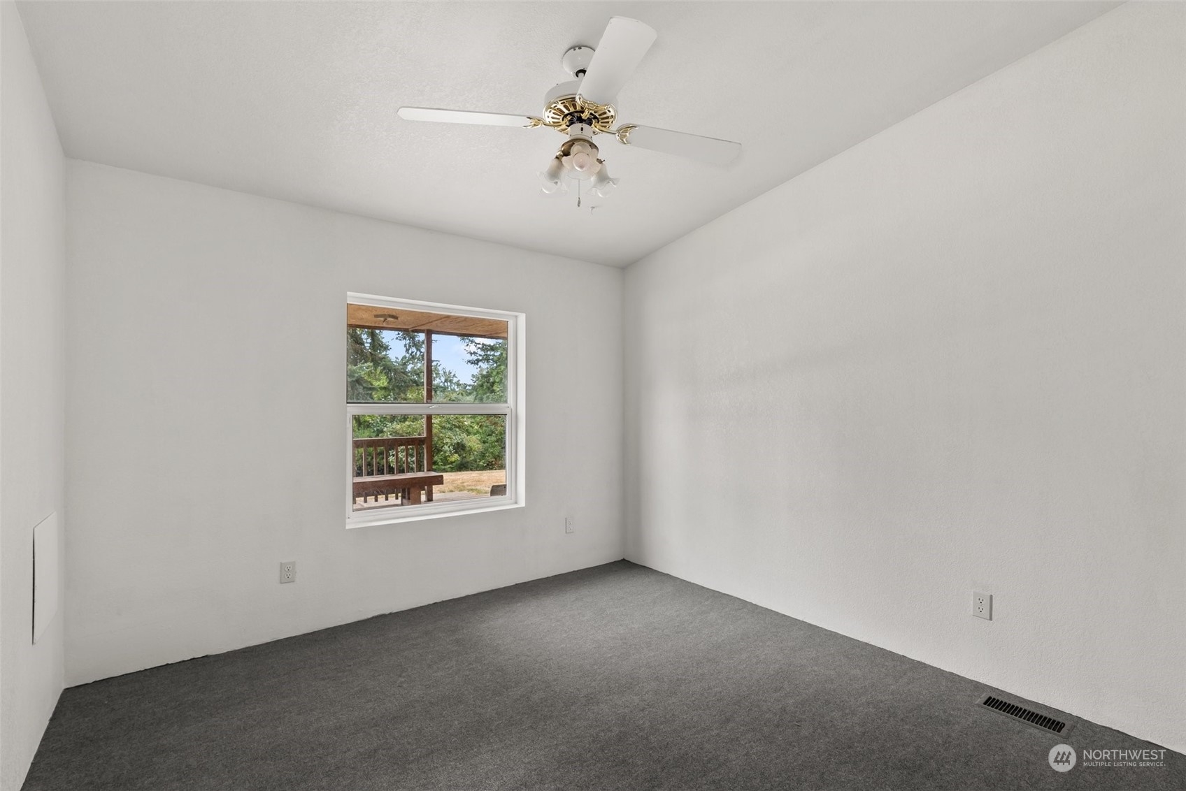 669 Twin Oaks Road Chehalis, WA 98532 - Photo 17 of 33 an empty room with a window and a ceiling fan
