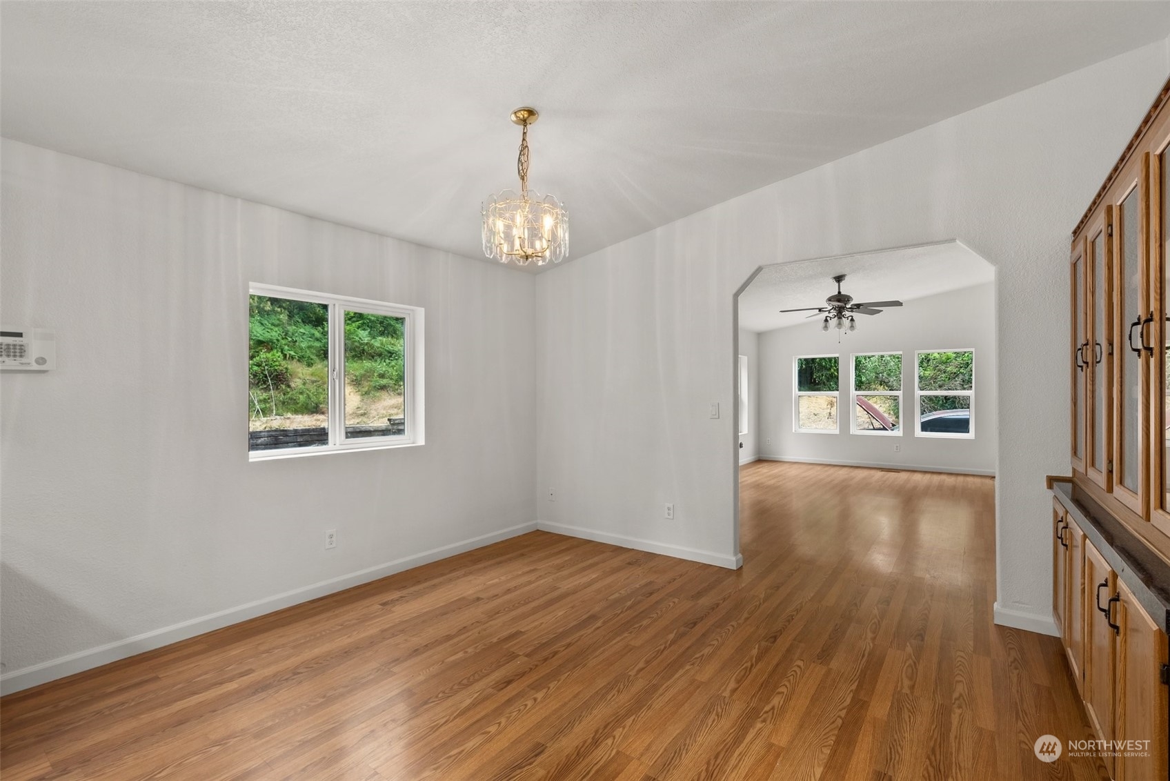 669 Twin Oaks Road Chehalis, WA 98532 - Photo 8 of 33 an empty room with wooden floor chandelier and windows