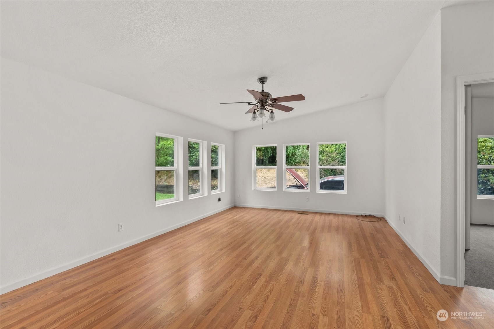 669 Twin Oaks Road Chehalis, WA 98532 - Photo 10 of 33 a view of an empty room with a window and wooden floor