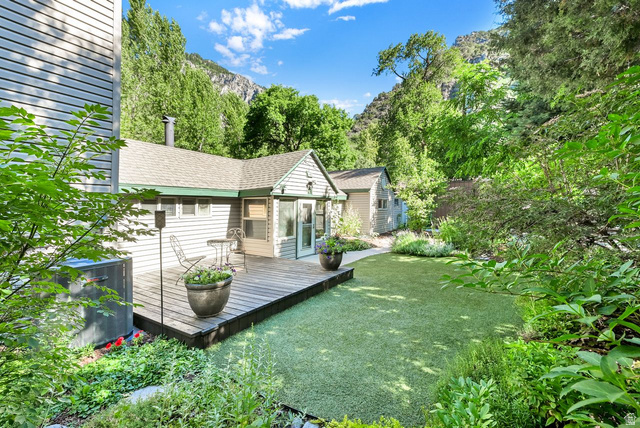 655 Ogden Canyon Road Ogden, UT 84401 - Photo 1 of 50 Rear exterior with a wood deck, artificial turf lawn, and surrounding mature foliage