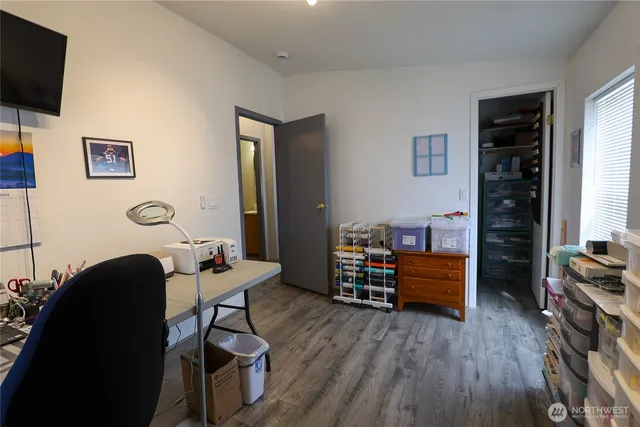 a view of a workspace with furniture and a window