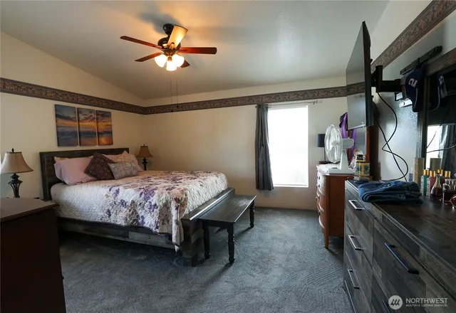 a bedroom with a bed and a chandelier