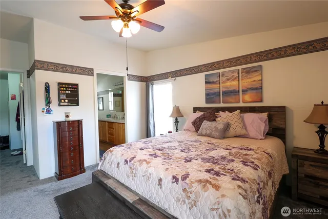 a large bed sitting in a bedroom and a chandelier