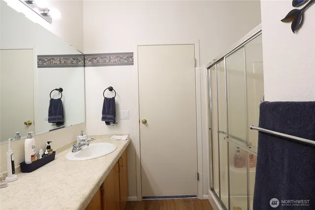 a bathroom with a double vanity sink and a mirror