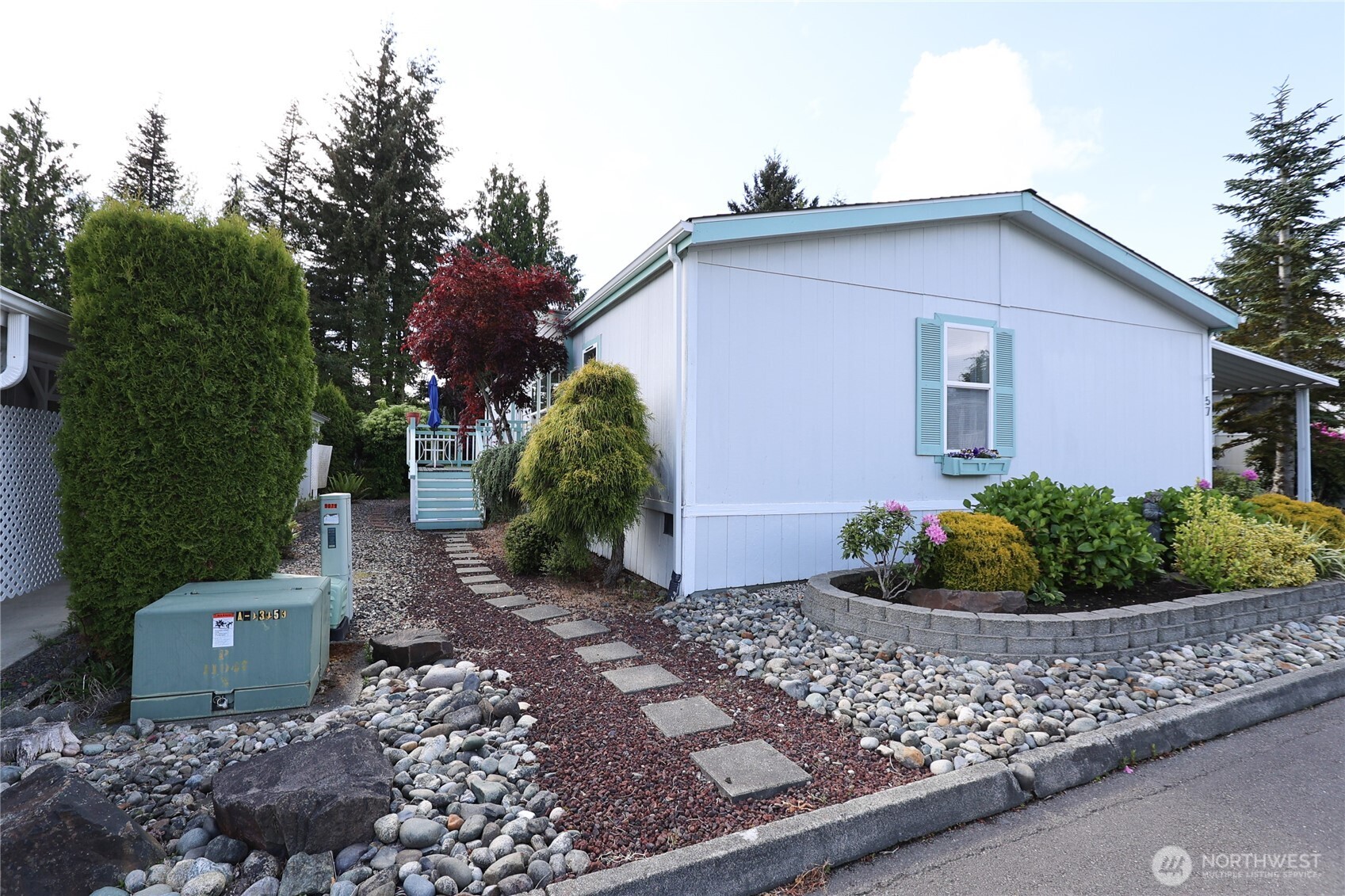 1427 100th Street Southwest, Unit 57 Everett, WA 98204 - Photo 25 of 38 a view of a house with a yard and plants