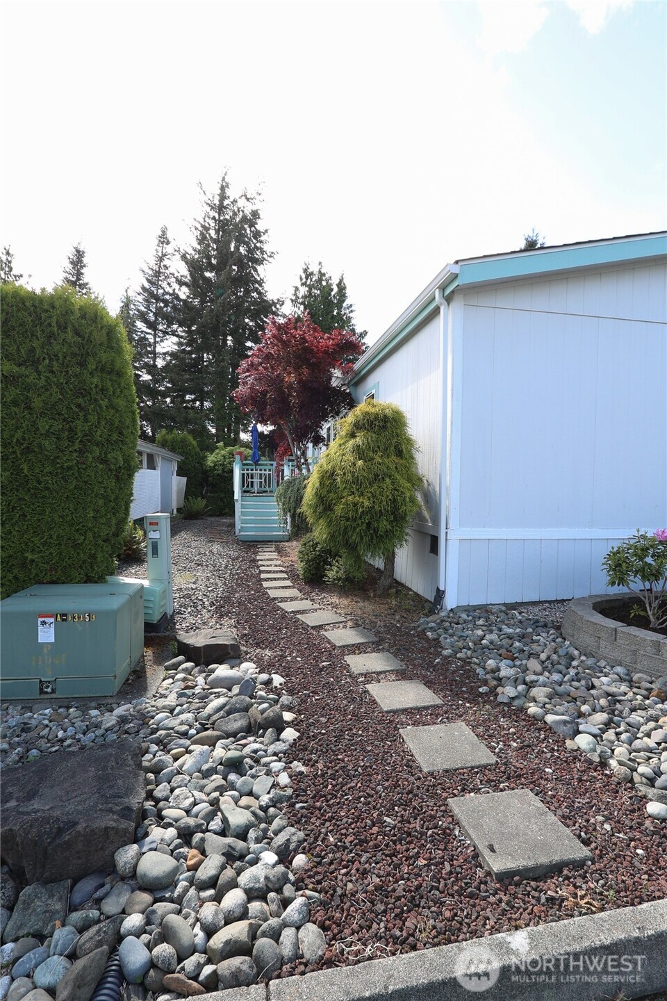 1427 100th Street Southwest, Unit 57 Everett, WA 98204 - Photo 26 of 38 a view of a backyard with plants and a tree