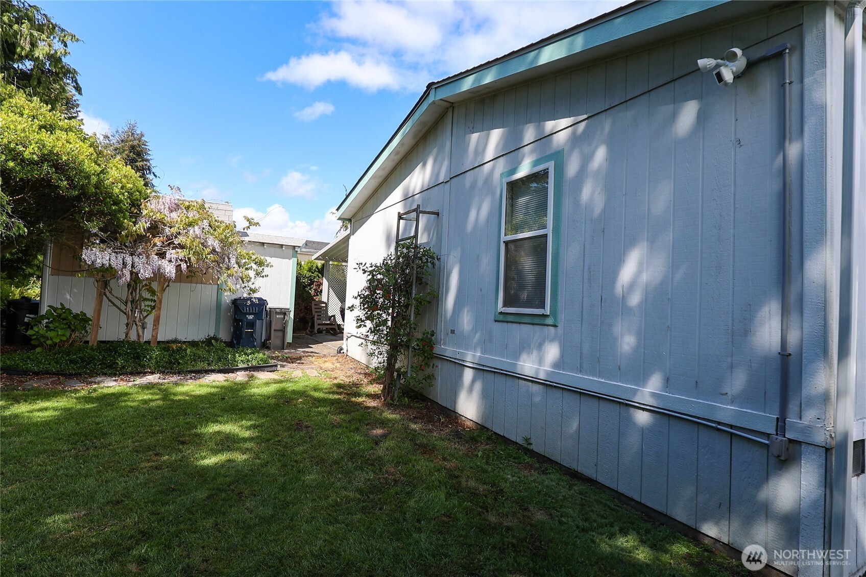 1427 100th Street Southwest, Unit 57 Everett, WA 98204 - Photo 28 of 38 a backyard of a house with lots of green space and outdoor seating