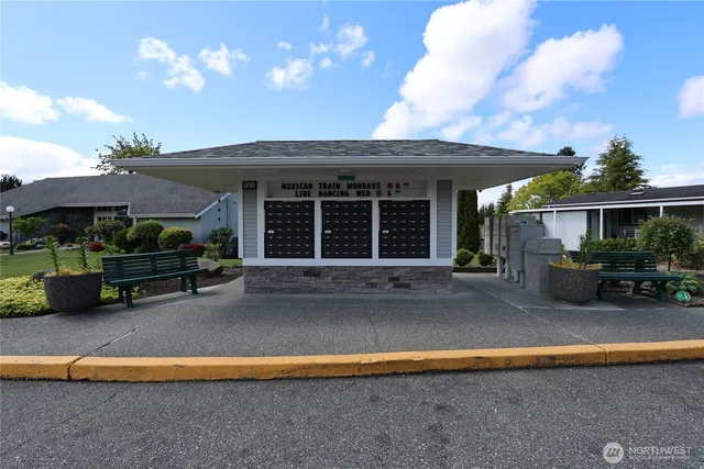 a view of a house with backyard and sitting area