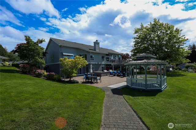 a front view of a house with garden and sitting area